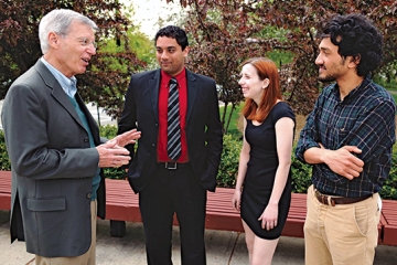 Dennis Bathory, professor of political science and director of the program, speaks with students